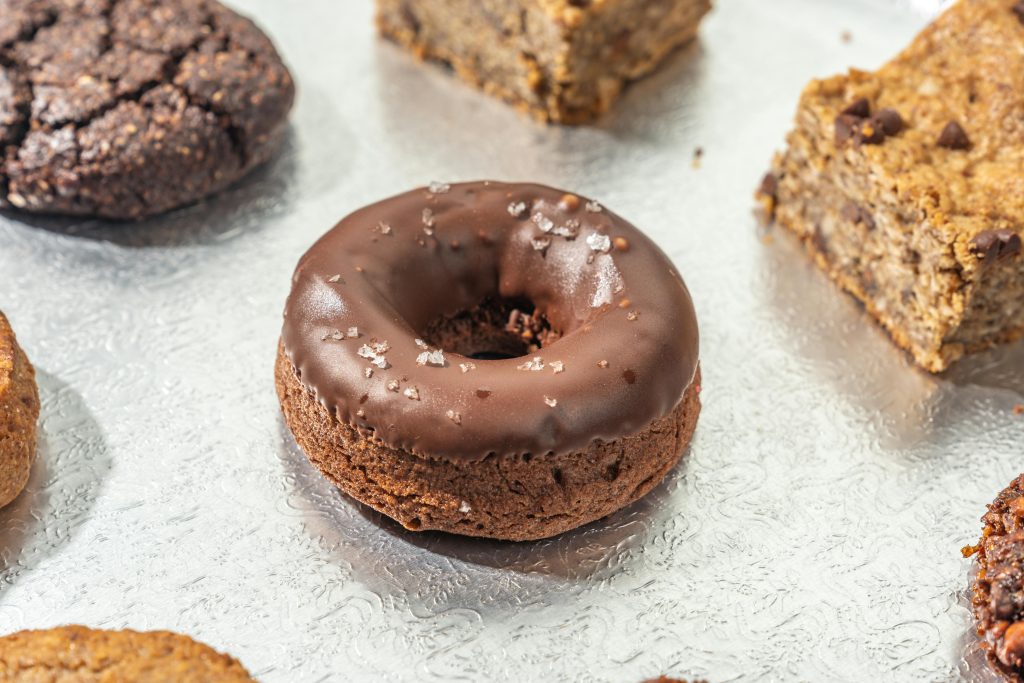 Mouthwatering chocolate donut topped with salt flakes, perfect for dessert lovers.